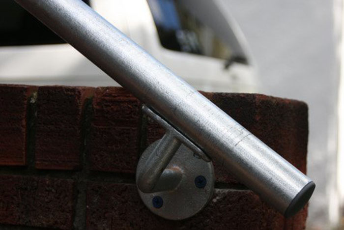 outdoor handrail mounted onto brick