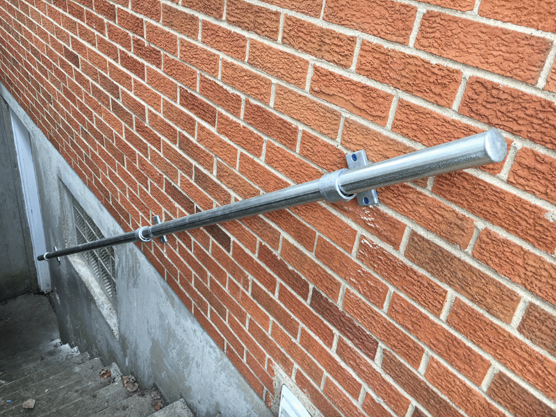 wall mounted handrail on a brick wall